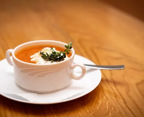 Tomatencrèmesuppe mit Rahmtupfer und frischen Kräutern
